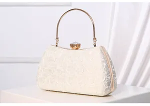 Elegant evening clutch bag featuring metal handle and crystal clasp, ideal for formal events.