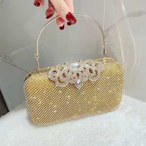 Gold rhinestone evening clutch bag detail showing sparkling crystals and metallic handle.