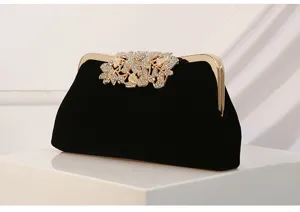 Elegant black velvet evening clutch with sparkling rhinestone leaf clasp for special events.