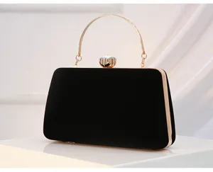 Black velvet evening clutch detail showing gold metal frame, handle and crystal clasp.