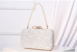 Elegant white pearl clutch bag with crystal bow for evening party dress and wedding events.
