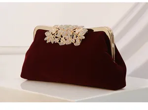 Elegant velvet evening clutch bag with sparkling rhinestone leaf clasp, perfect for party wear.