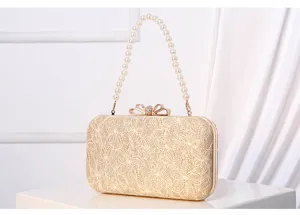 Elegant gold lace evening clutch bag with pearl handle and bow clasp for parties and weddings.