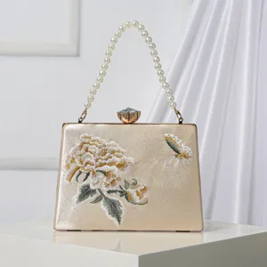 Elegant champagne satin evening clutch bag featuring floral embroidery pearl handle.