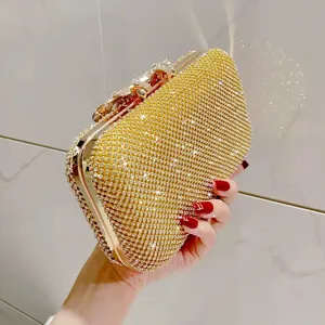 Detailed view of the luxury rhinestone evening clutch bag with sparkling diamonds and gold frame.