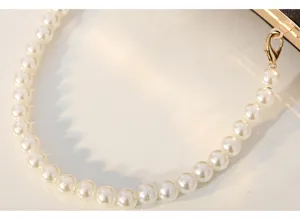 Elegant pearl bag strap detail for vintage evening clutch, high quality gold metal clasp.