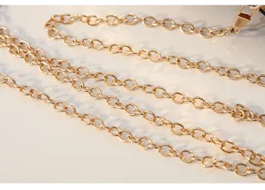 Gold metal chain strap detail for evening bags and purses, durable and elegant accessory.