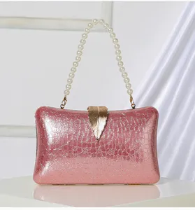 Elegant pink glitter evening clutch bag featuring a stunning gold leaf clasp and chic pearl handle.