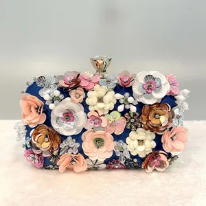 Detailed view of handmade floral evening clutch with dazzling sequins and rhinestones.
