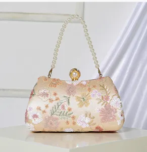 Elegant pearl handle floral sequin evening bag detail, sparkling embroidery clutch purse.