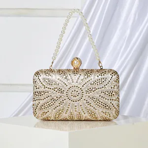 Elegant gold rhinestone evening clutch bag with pearl handle and sparkling floral design.