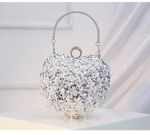 Close-up detail of the stunning crystal heart evening bag showing sparkling sequin beading.