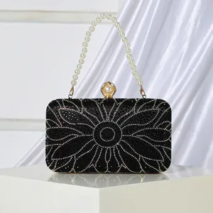 Black rhinestone evening clutch bag with pearl handle and floral crystal design for women.
