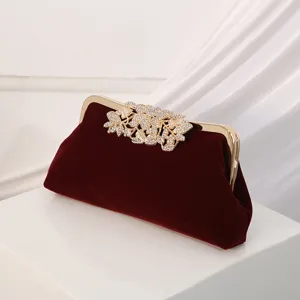 Elegant wine red velvet evening clutch bag with sparkling rhinestone floral clasp for women.