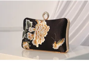 Silk embroidered evening clutch bag with gorgeous floral pattern and luxury ring handle.