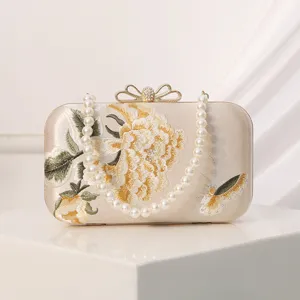 Elegant embroidered evening clutch bag with pearl strap for women's party dresses.