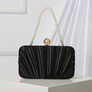 Black pleated evening clutch bag with pearl handle and metal clasp for formal party