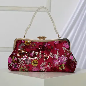 Wine red sequin floral evening clutch bag with pearl handle and metal frame clasp main view.