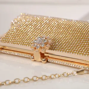 Gold rhinestone evening clutch bag with flower clasp, elegant sparkling wedding purse.