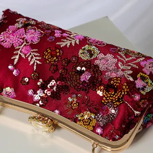 Elegant burgundy sequin floral evening clutch with gold metal frame and pearl clasp for dress.