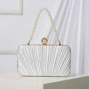Elegant white pleated evening clutch bag with pearl handle and clasp for weddings and parties.
