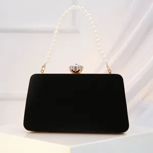 Elegant black velvet evening clutch bag with pearl handle and sparkling crystal clasp for parties