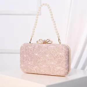 Elegant pink lace evening clutch bag with pearl handle and sparkling rhinestone bow clasp.