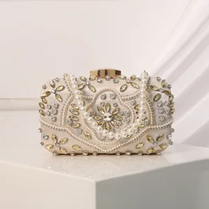 Elegant beaded evening clutch bag with pearls and rhinestones for women parties and weddings.