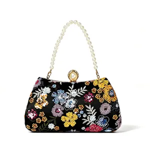 Elegant black beaded floral evening bag with pearl handle for party and wedding events.