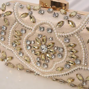 Elegant champagne beaded evening clutch bag with handmade rhinestones and faux pearls for women.