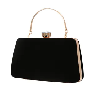 Elegant black velvet evening clutch with gold metal handle and crystal clasp for parties.