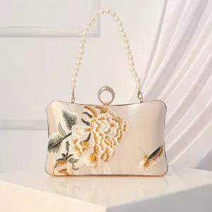 Elegant silk evening clutch bag with pearl handle and floral embroidery for women banquets.
