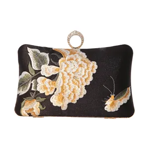 Elegant black silk embroidered evening clutch bag with floral design and crystal ring top handle.