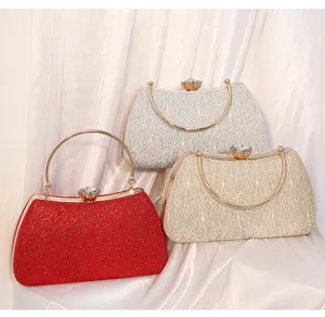 Elegant evening clutch bag with metal frame, crystal clasp, and delicate lace design detail.