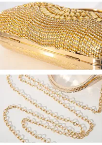Exquisite detail view of luxury rhinestone evening clutch with sparkling crystal gems and gold chain.