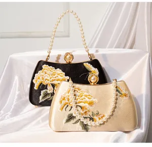 Exquisite Chinese style embroidered floral clutch bag detail with elegant pearl handle