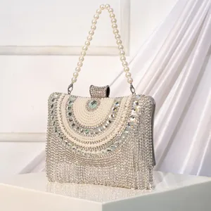 Close-up view of a luxury rhinestone and pearl fringe evening clutch bag with elegant details.