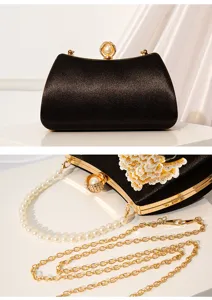 Elegant black evening clutch with embroidered floral details, pearl clasp, and metal chain.