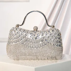 Stunning silver rhinestone evening clutch bag featuring metal handle and sparkling crystal fringe.
