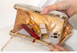 Detailed view of the pearl and rhinestone evening clutch bag showing its spacious interior.