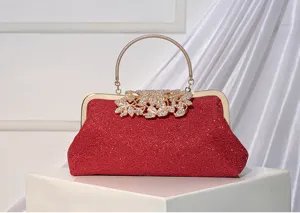 Elegant red lace evening clutch bag featuring a gold metal handle and crystal leaf clasp.