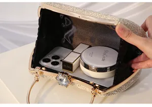 Elegant gold lace evening clutch bag with metallic frame, rhinestone clasp and capacity detail.