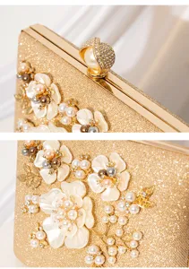 Close-up detail of luxury gold glitter evening clutch with pearls, floral appliques and rhinestones.