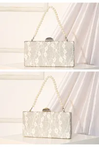 Detail view of elegant white lace evening clutch with pearl chain strap, sparkling sequin design.