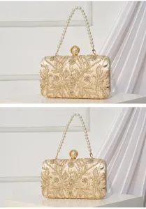 Gold evening clutch bag detail showing delicate floral embroidery and pearl handle clasp.