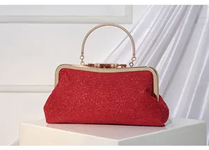 Red lace evening bag detail, sparkling clutch purse with gold metal handle and frame.