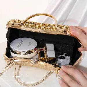 Elegant gold rhinestone evening clutch bag with metal handle for party and wedding events.
