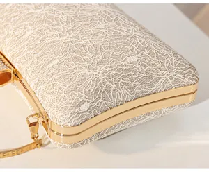 Exquisite lace evening clutch bag detail, champagne glitter fabric with gold metal frame.