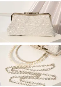 Detailed view of vintage lace evening clutch bag with pearl and metal chain straps, elegant.