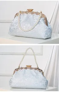 Detailed view of the elegant light blue lace clutch bag featuring a stunning pearl chain handle.
